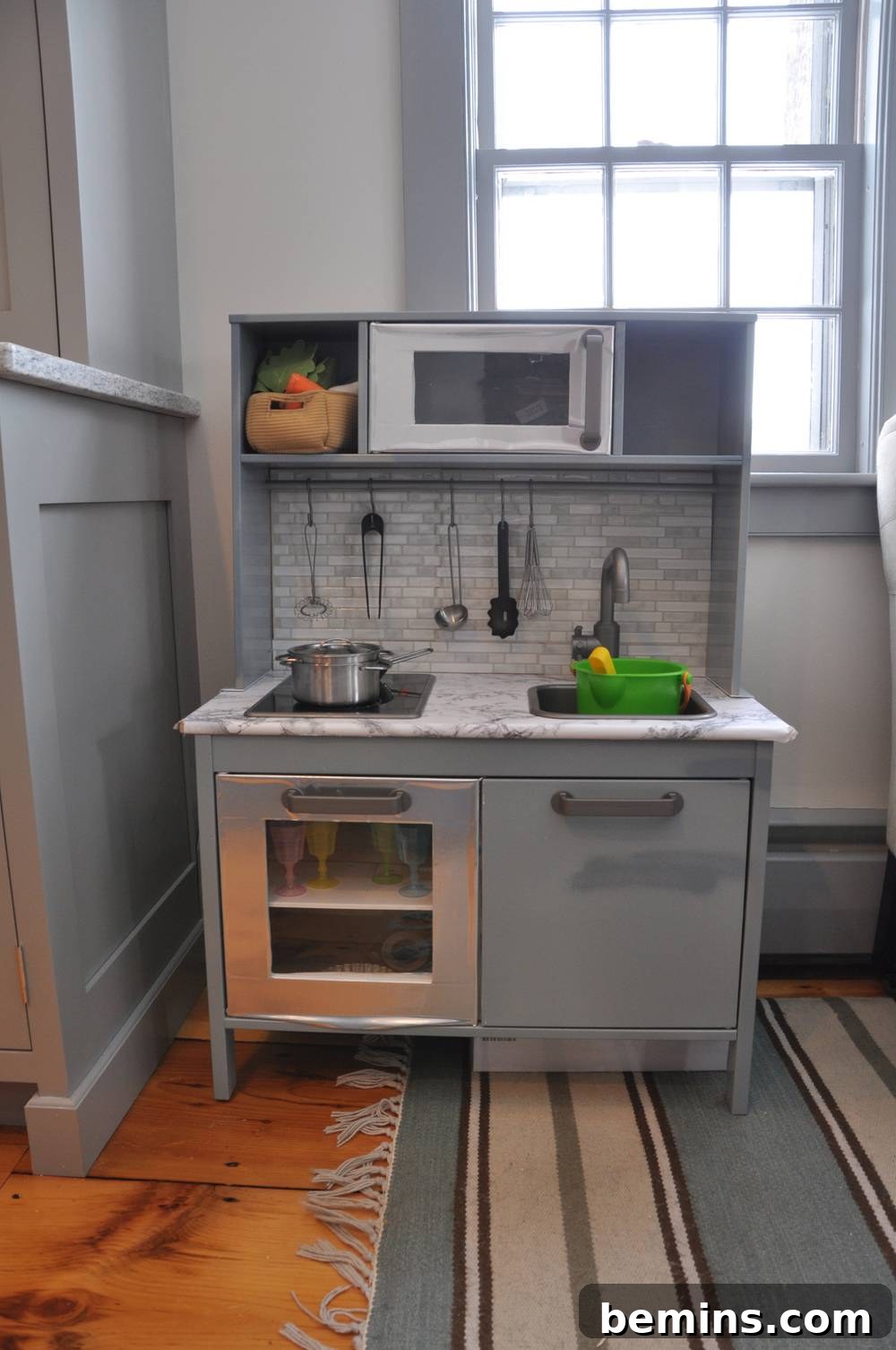 10 Clever IKEA Play Kitchen Transformations for Little Chefs 12 Trendy IKEA Duktig play kitchen featuring a faux marble countertop and peel-and-stick tile backsplash for a modern look.
