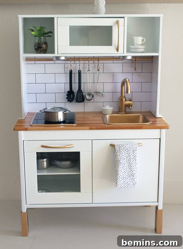 10 Clever IKEA Play Kitchen Transformations for Little Chefs 13 Realistic IKEA Duktig play kitchen with subway tile backsplash, giving it a true kitchen feel for immersive play.