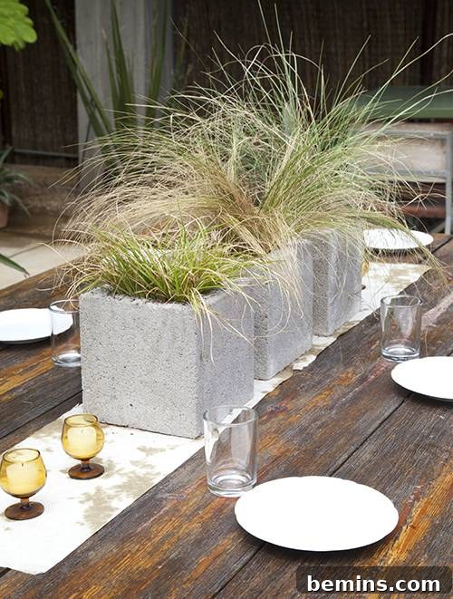 Cinder block centerpieces filled with grass and moss