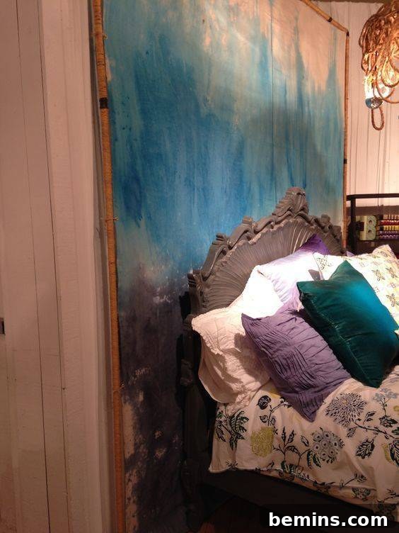 Blue colored canvas drop cloth wall art behind the wooden bed. Painted Canvas Behind A Bed Canvas Drop Cloth Wall Art.