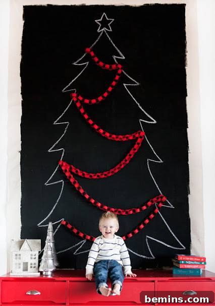 Black drop cloth wall art that looks like a Christmas tree with red decorations on it. Chalk Board Painted Canvas Drop Cloth Wall Art.