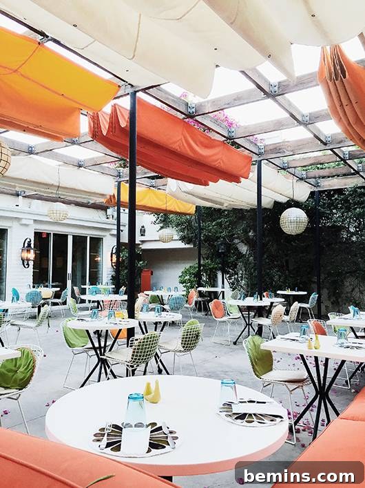 Norma's restaurant patio at The Parker Palm Springs with retro, colorful outdoor seating.