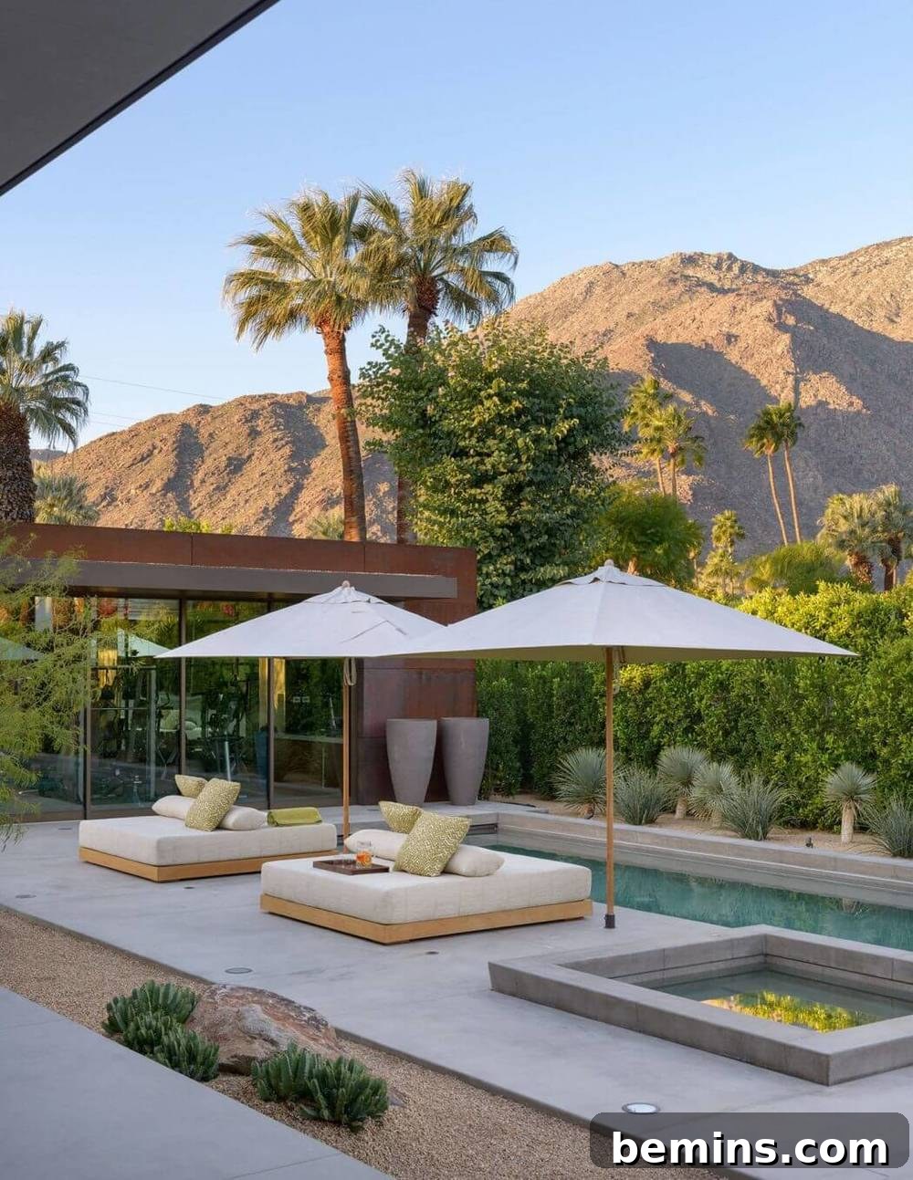 Palm Springs retreat patio by Carré Designs with muted tones and clean lines against a desert backdrop.