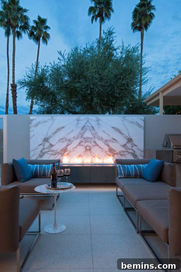 The Cooper Residence patio in Palm Springs featuring a striking Calacatta marble backdrop and modern design.