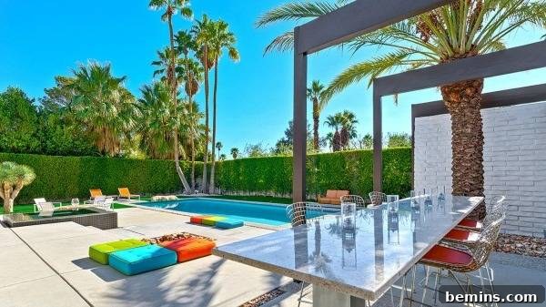 Palm Springs pool area with vibrant, bold-colored cushions surrounding the swimming pool.