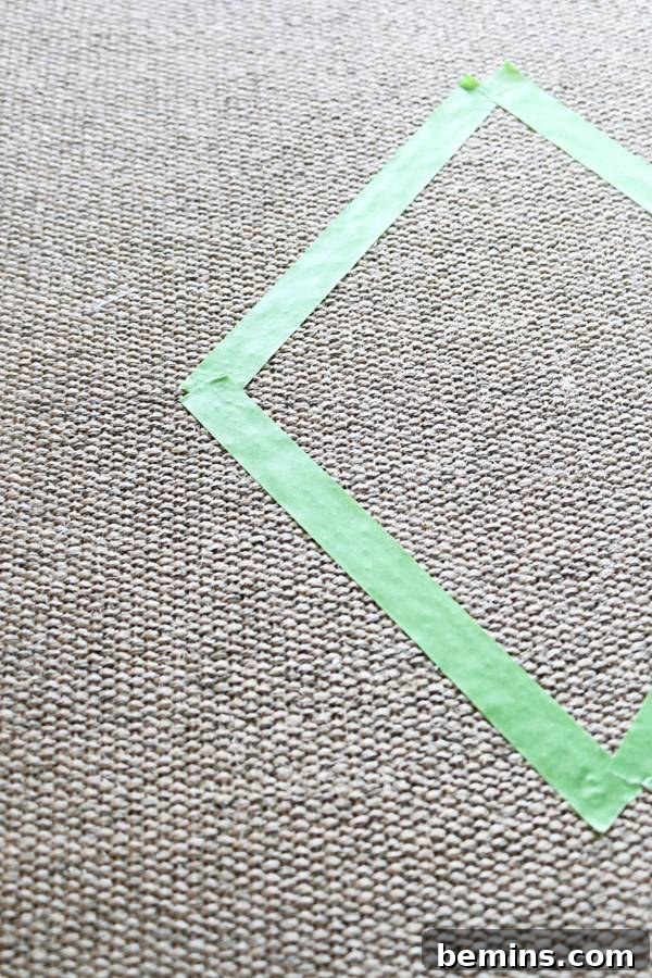 Taping a modern diamond design on an outdoor rug