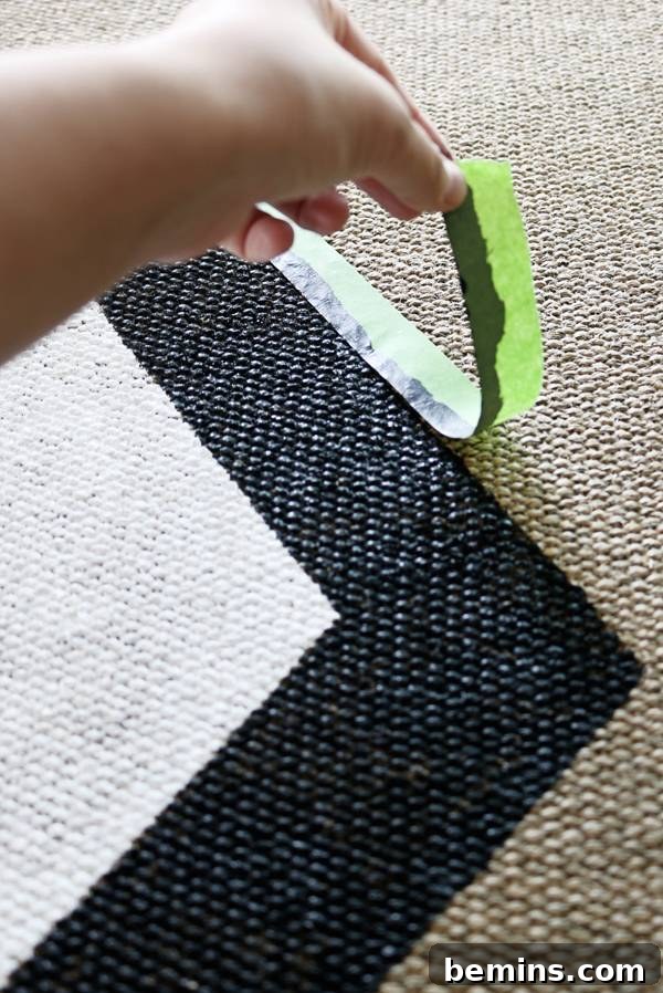Removing painter's tape from a freshly painted outdoor rug