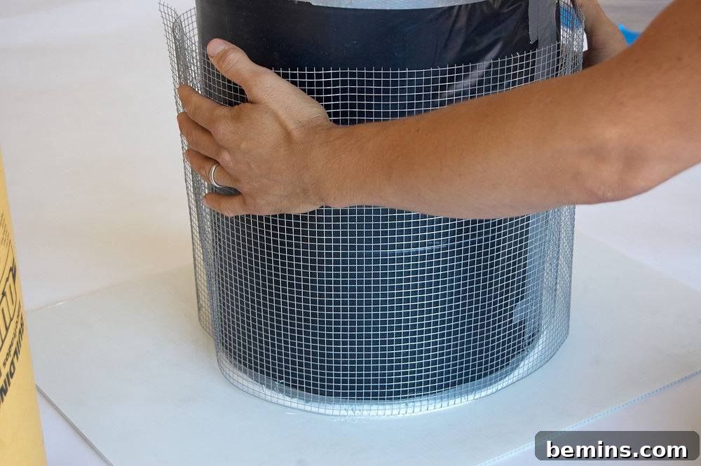 A person lifting up a blue round item with a plastic cover.