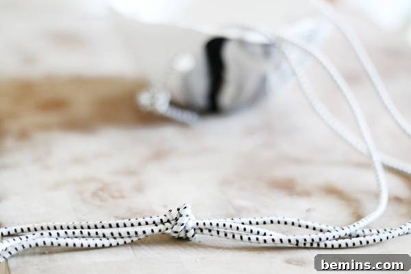 Create Beautiful DIY Hanging Clay Planters 11 Securing the three cords with a knot at the top for hanging