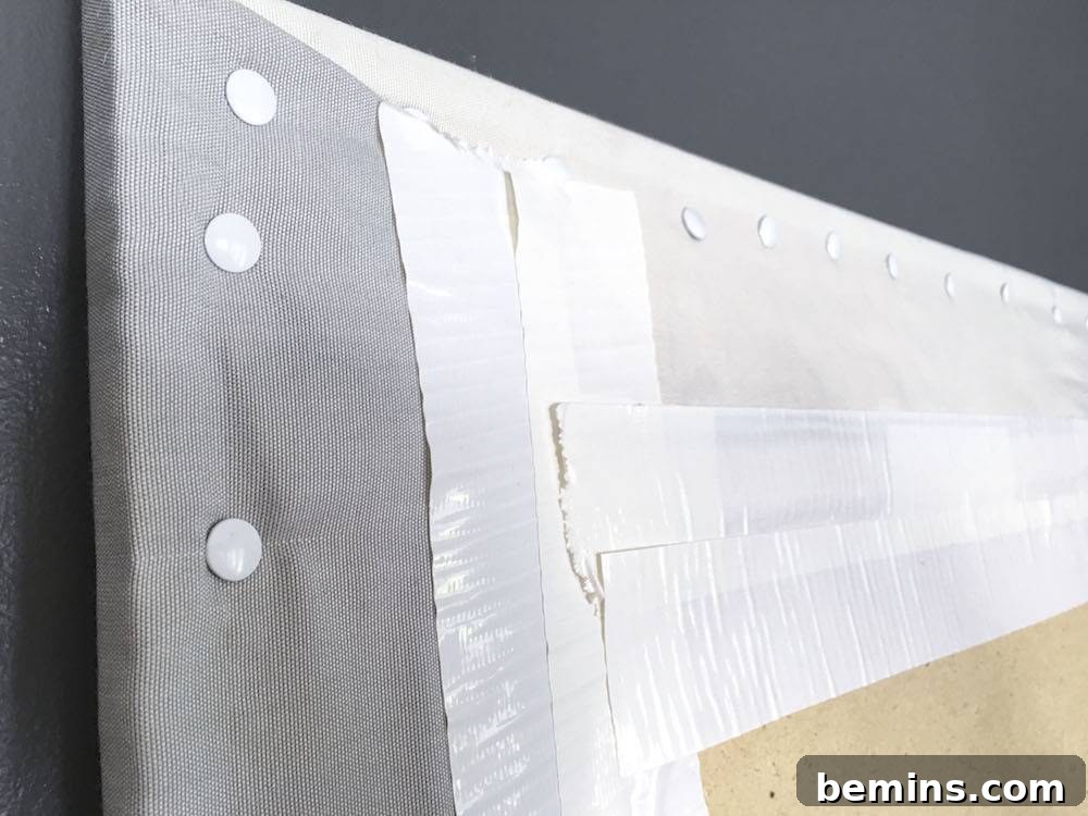 Close-up of how to fold the corners of the fabric when covering the bulletin board.