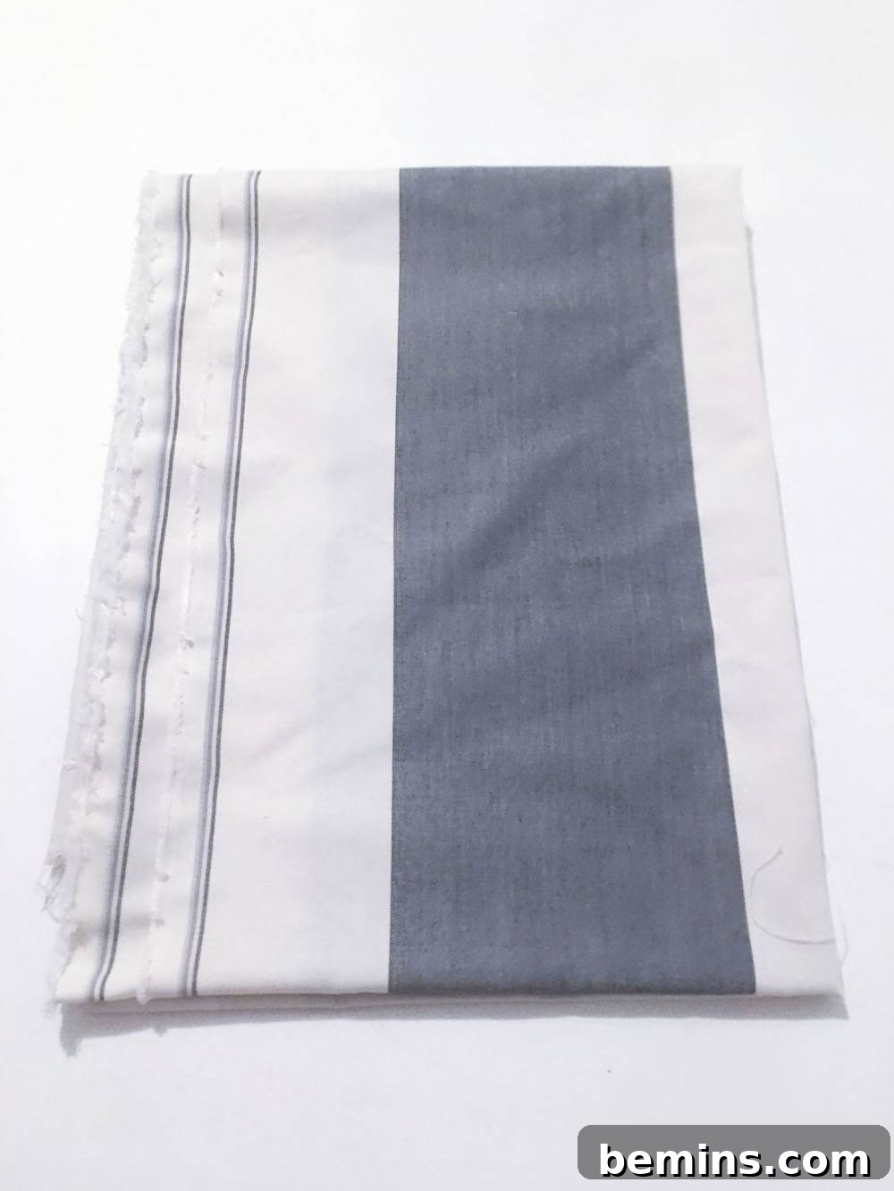 Recovering the bulletin board with fabric.