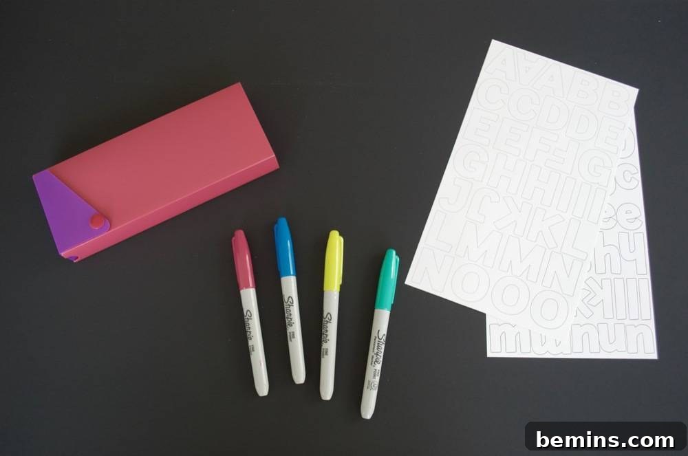 Kid-Friendly DIY: Personalized Pencil Pouches for School 3 Pink and purple pencil box laid out with four sharpies and white paper: Ready for personalization