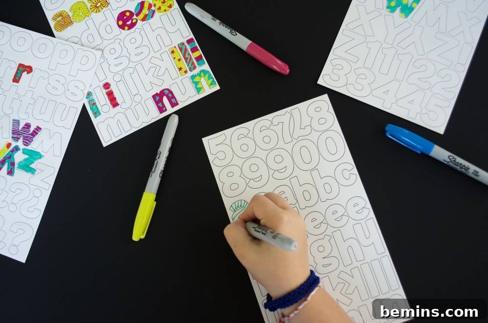 Kid-Friendly DIY: Personalized Pencil Pouches for School 5 A person is using a permanent marker to color in a sheet of numbers and letters: Adding detail to the stickers