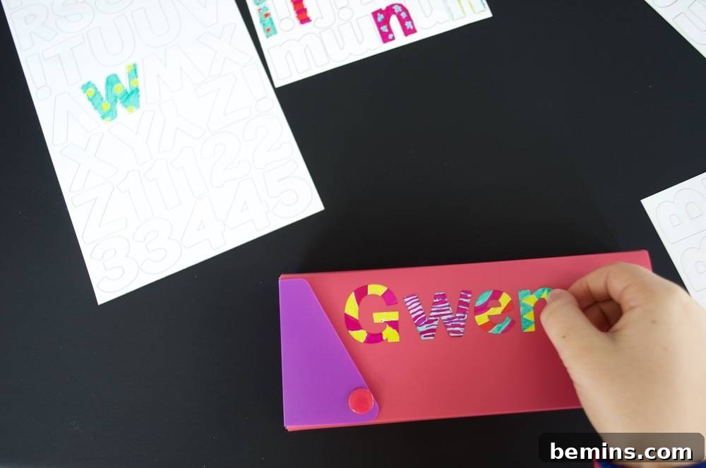 Kid-Friendly DIY: Personalized Pencil Pouches for School 6 Construction paper with various colored letters used to design an ornamental piece: Exploring design options