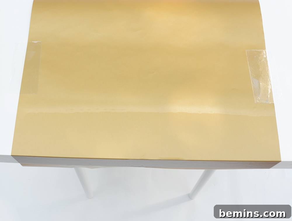 IKEA Hack: Marius Stool End Table Transformation 8 Smoothing contact paper for a seamless finish