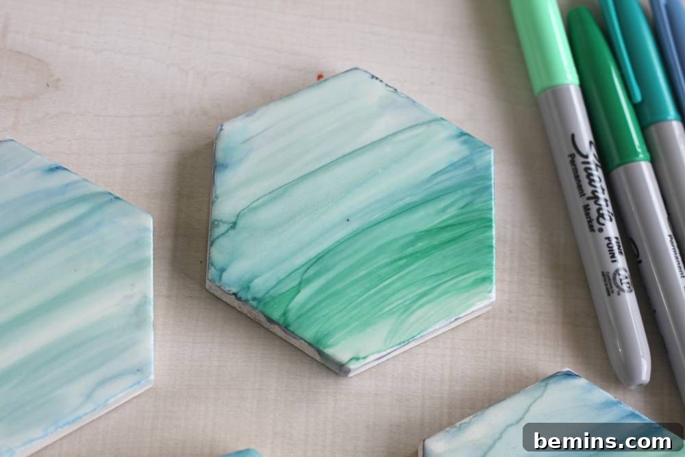 DIY Sharpie Coasters: A Creative Home Decor Project 5 Use a soft brush dipped in the rubbing alcohol to create a painterly effect in the marker.