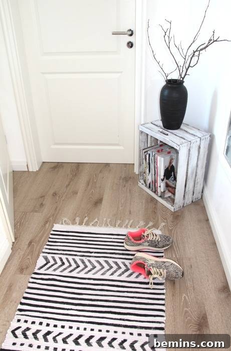 Two stylish shoes lying on top of a chic rug placed on the wooden floor of a room.