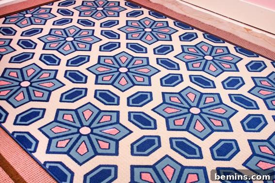 A rug adorned with beautiful blue, pink, and white floral shapes.