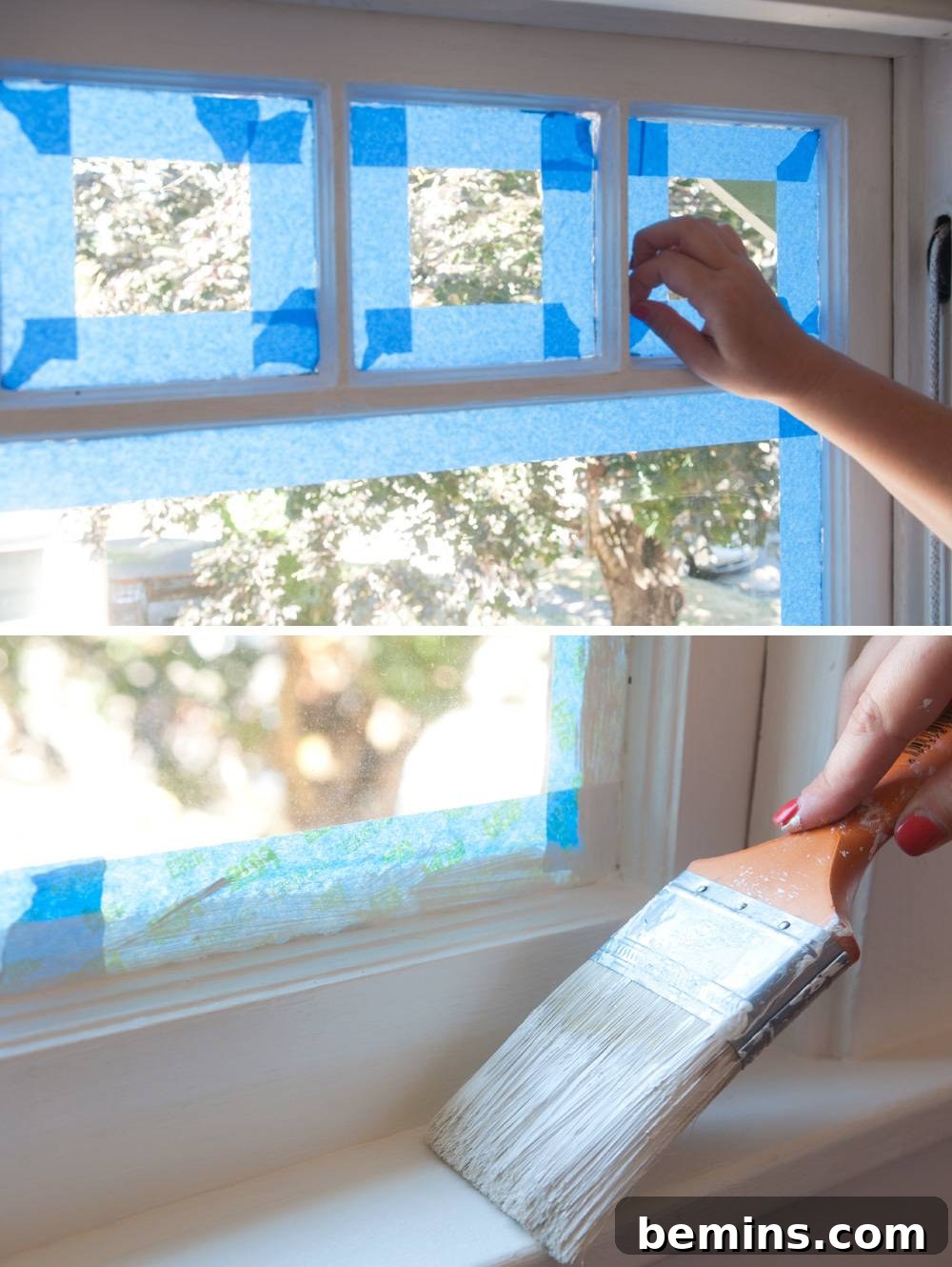 A person applying blue painter's tape to a window pane.