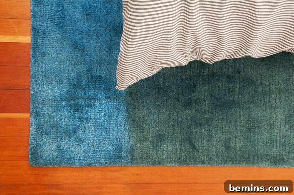 A white pillow on a blue towel on a brown floor