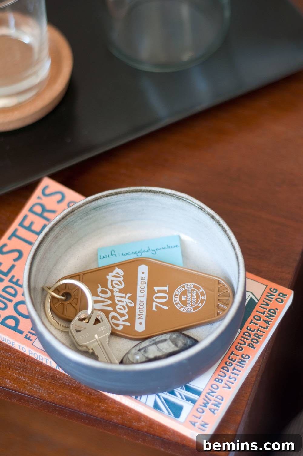 A small bowl containing a keychain with a key.