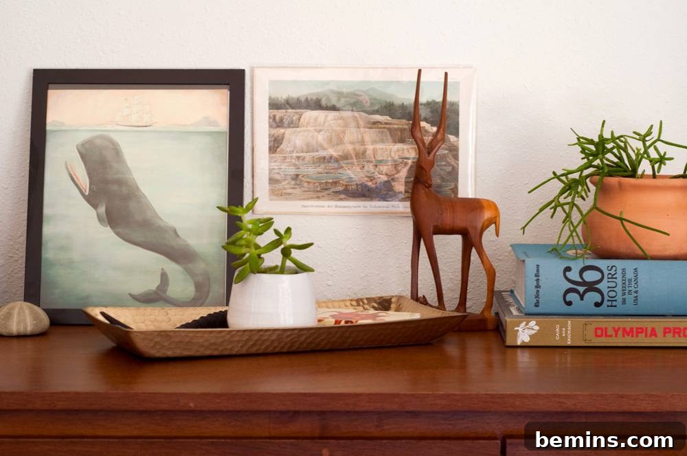 A cute simple decorated end table with plants and books.