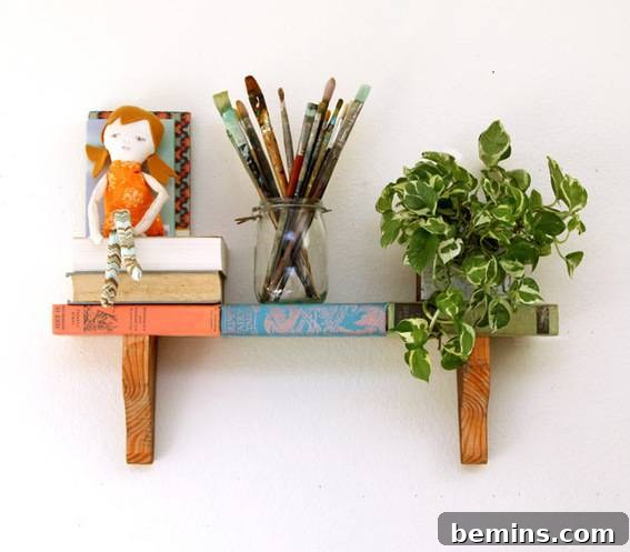 A small shelf has a plant, a pen jar and some books on it.