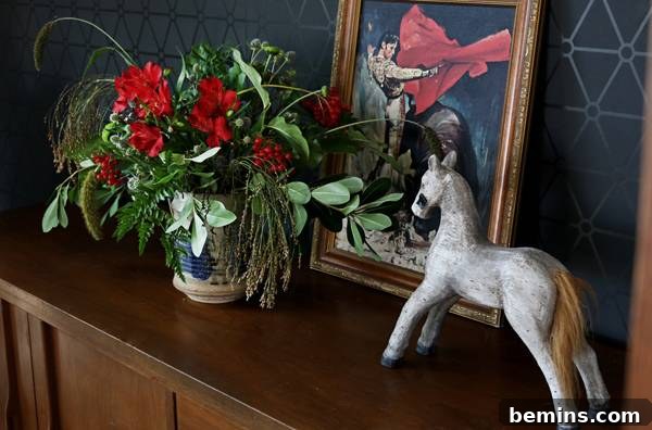 A wider shot of a completed fall bouquet in a vase.