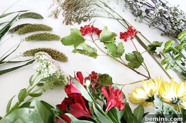 Close-up of the materials needed to create fall bouquets: greenery, flowers, and vases.