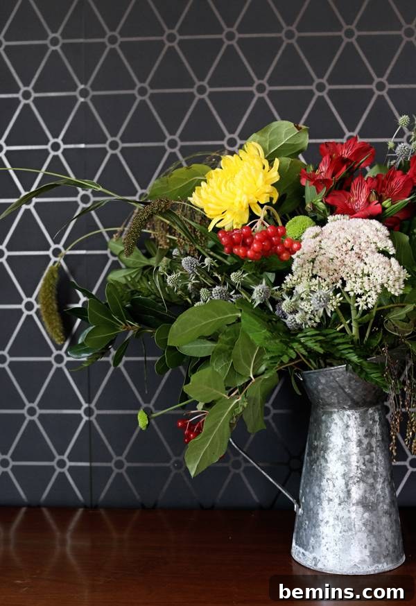 Adding finishing touches of greenery and filler to create a full and complete bouquet.