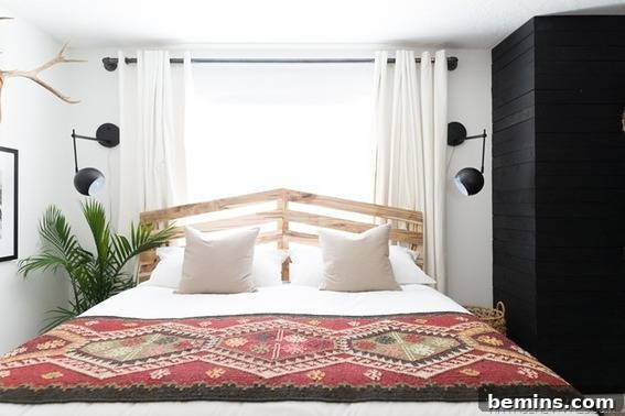 A well-decorated bedroom featuring a bed with stylish bed sheets and pillows.