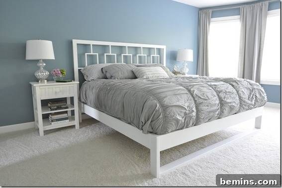 Bedroom featuring a bed, pillows, and a mini table with a night lamp.