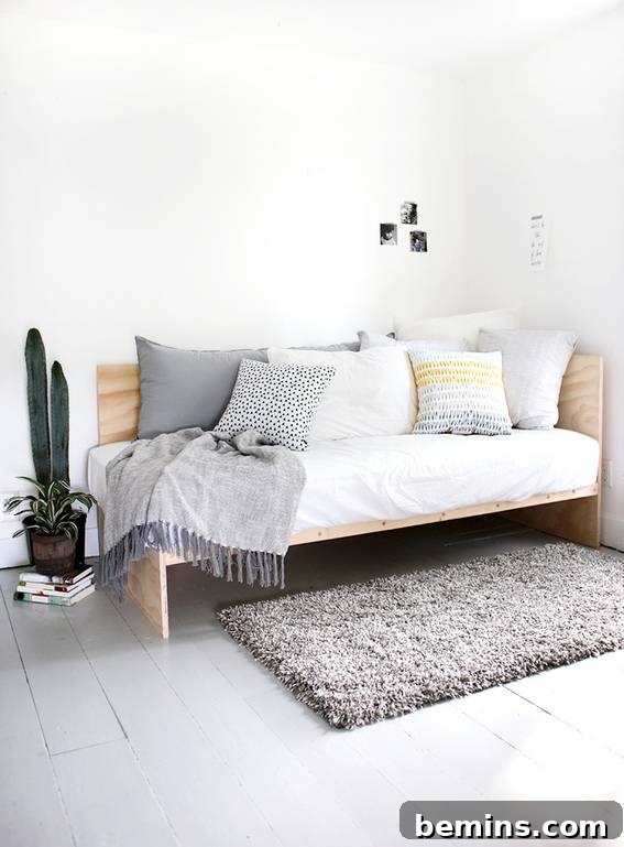 A white room featuring a bed and pillows.