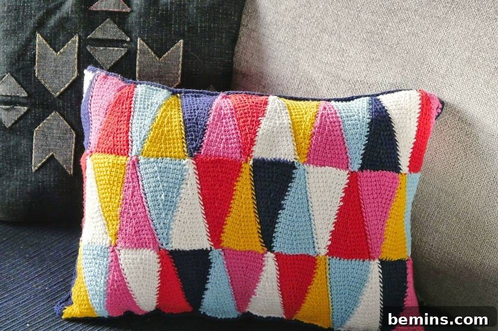 Colorful crocheted pillow cover made from yarn scraps