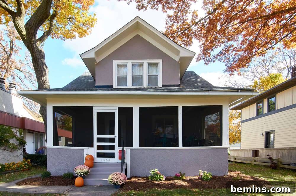 A screened porch on the front of a house: After the transformation - showcasing the revitalized exterior and inviting porch.