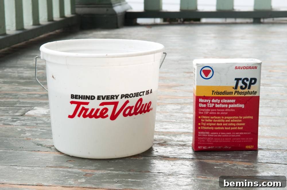 Bucket and TSP cleaner sitting on an old porch floor.