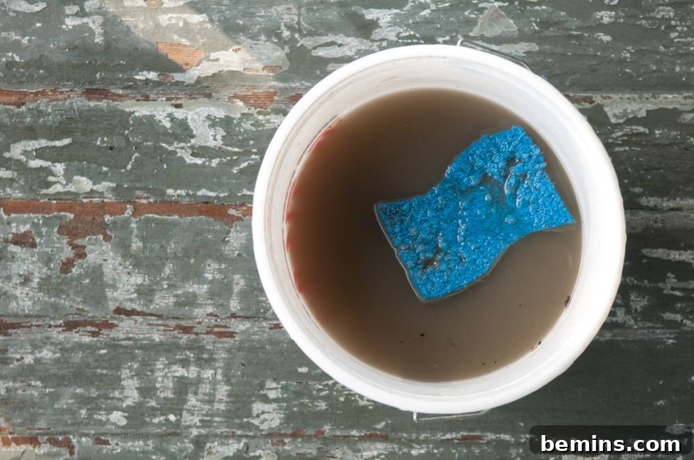 Blue sponge in a cup of coffee on a table.