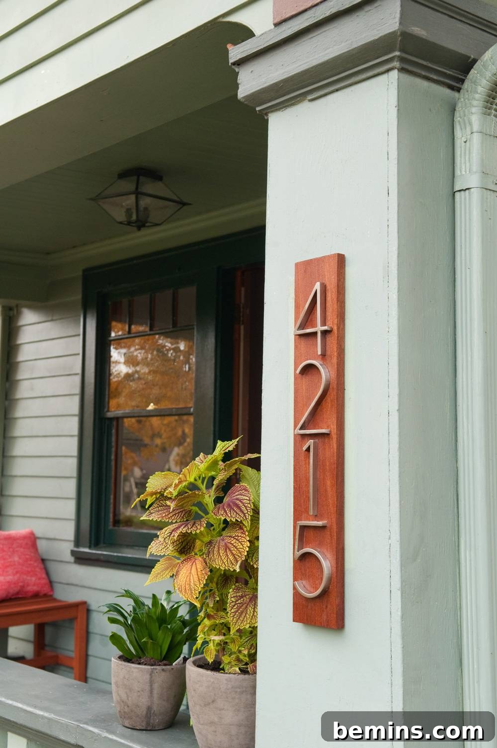 The house number 4210 displayed on the side of the house with a porch.