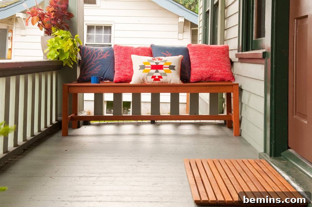 Colorful pillows arranged on a front porch bench, adding comfort and style.