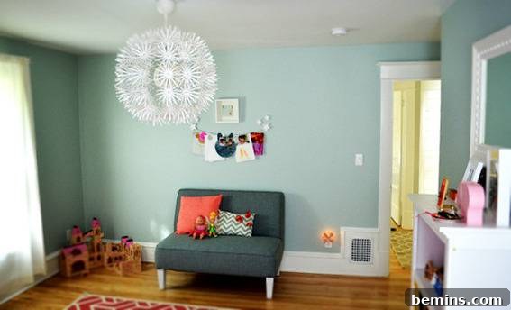 Before: A small green couch on a wood floor in a green living room with a giant white burst light fixture.