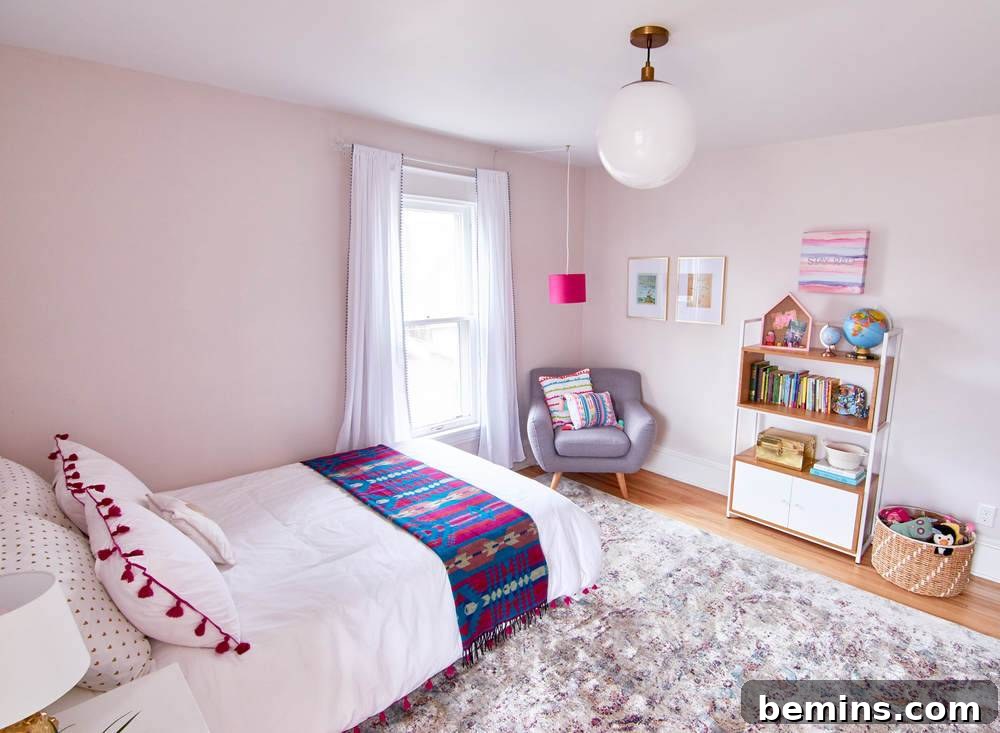 A Whimsical Retreat: Designing a Dream Bedroom for Our Daughter 19 A bed is set up on a rug in a light pink room.