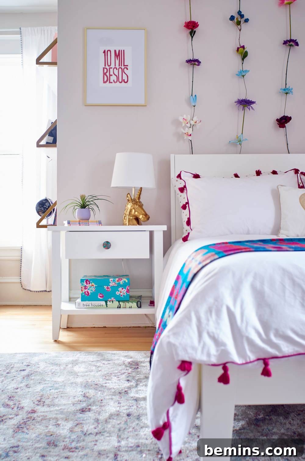 A Whimsical Retreat: Designing a Dream Bedroom for Our Daughter 5 A close-up of Ayla's bed, showcasing a white duvet with pink tassels and a stylish throw blanket, highlighting the room's color scheme.