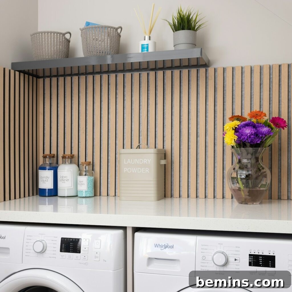 A white washer sitting next to a dryer on top of a counter